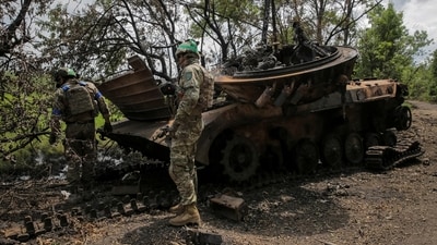 Ukrainian service members check a destroyed Russian a BMP-2 infantry fighting vehicle, amid Russia's attack on Ukraine. (REUTERS)