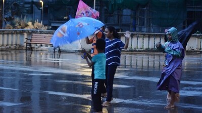 Children enjoy in the rain, in Thane, India, on Tuesday, June 13, 2023. (Praful Gangurde /HT Photo)
