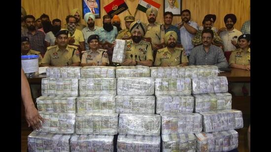 Ludhiana police commissioner Mandeep Singh Sidhu with other senior police officials sharing details about the arrest. (Gurpreet Singh/HT)