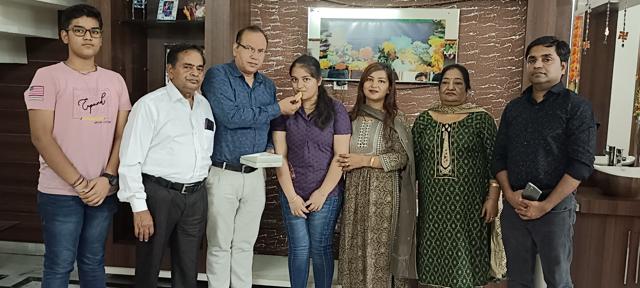 Pranjal celebrating her success with her family in Malerkotla. (HT Photo)