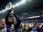 PSG forward Kylian Mbappe holds up his trophy during the ceremony following the team's French League One soccer match loss to Clermont, in Paris PSG forward Kylian Mbappe holds up his trophy during the ceremony following the team's French League One soccer match loss to Clermont, in Paris