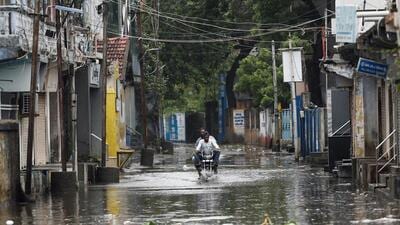 A man rides a motorcycle through a waterlogged street in Mandvi, before the arrival of cyclone Biparjoy, in Gujarat on Thursday. (Reuters) A man rides a motorcycle through a waterlogged street in Mandvi, before the arrival of cyclone Biparjoy, in Gujarat on Thursday. (Reuters)