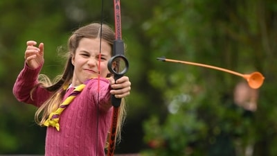 Britain's Princess Charlotte tries her hand at archery. (AP) Britain's Princess Charlotte tries her hand at archery. (AP)