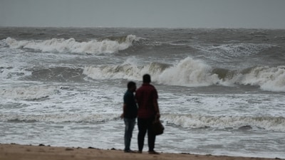 People watch as waves hit Mandvi Beach before the arrival of cyclone Biparjoy in the western state of Gujarat, India. (Reuters)