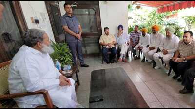 Haryana home minister Anil Vij meets farmers in Ambala on Thursday.