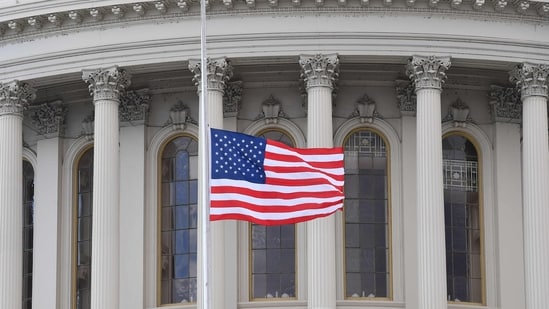 A US flag is raised after the inauguration of Joe Biden as the 46th US President on January 20, 2021, at the US Capitol in Washington, DC. (Photo by ANGELA WEISS / AFP) (AFP)
