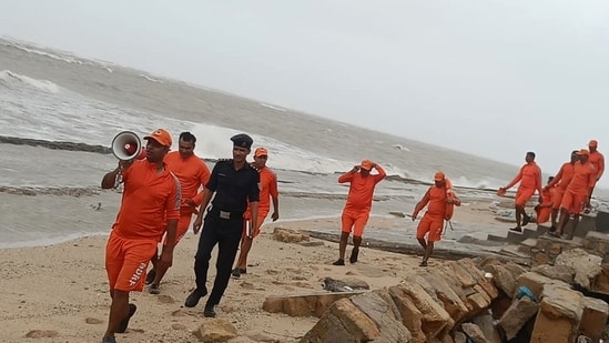 An NDRF personnel makes announcements as precautionary measures ahead of the landfall of Cyclone Biparjoy, on Wednesday, June 14, 2023. (PTI)
