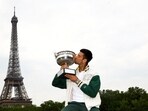 Novak Djokovic kisses the trophy in front of the Eiffel Tower after winning the men's singles French Open title
