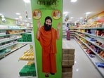 A hoarding with an image of Baba Ramdev is seen inside a Patanjali store. 