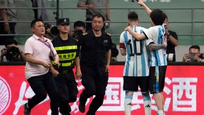 Security officers pursue a fan as he hugs Argentina's Lionel Messi friendly against Australia (AP) Security officers pursue a fan as he hugs Argentina's Lionel Messi friendly against Australia (AP)
