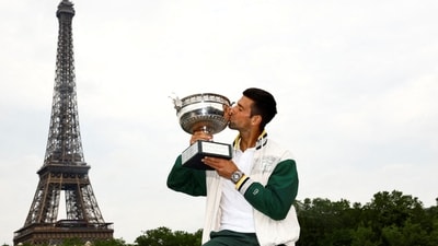 Novak Djokovic kisses the trophy in front of the Eiffel Tower after winning the men's singles French Open title (REUTERS)