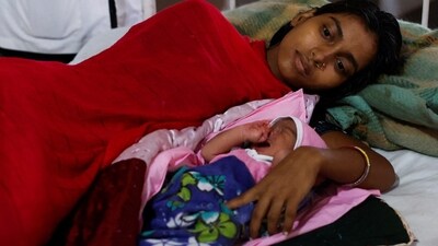 Rashida Javed Hashmi and her newborn son are seen at a government hospital after giving birth to him, after Cyclone Biparjoy made landfall, in Naliya in the western state of Gujarat, on Friday. (REUTERS)