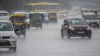 Vehicles ply on a road amid rainfall, in Gurugram, Friday. (PTI) Vehicles ply on a road amid rainfall, in Gurugram, Friday. (PTI)