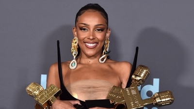 Doja Cat poses in the press room with her awards (Jordan Strauss/Invision/AP) Doja Cat poses in the press room with her awards (Jordan Strauss/Invision/AP)