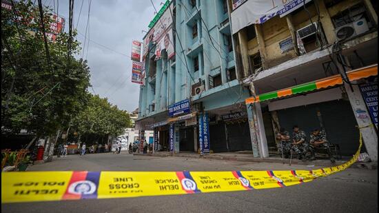 Security personnel outside the coaching centre where the fire broke out on Thursday, in Mukherjee Nagar in New Delhi on Friday. (Sanchit Khanna/HT Photo)