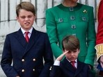 Prince George, left, and Prince Louis, greet the crowd from the balcony of Buckingham Palace.