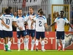 England's forward Harry Kane (C) celebrates with teammates after scoring a penalty during the UEFA Euro 2024 Group C qualifiers match