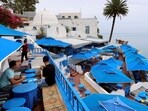 People sit in a cafe in Sidi Bou Said, a popular tourist destination, near Tunis, Tunisia. Tunisia tourist revival to bring some badly needed foreign currency for crisis-hit economy 