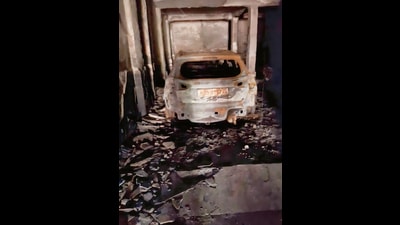 Officials said that 11 vehicles, including two cars were charred due to the fire as it originated from an electrical panel situated on the stilt floor. (Sakib Ali/HT Photo) Officials said that 11 vehicles, including two cars were charred due to the fire as it originated from an electrical panel situated on the stilt floor. (Sakib Ali/HT Photo)