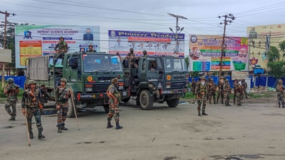 Security personnel stand guard at violence-hit Konung Mamang area during the ongoing ethnic clashes, in Imphal East district. (PTI) Security personnel stand guard at violence-hit Konung Mamang area during the ongoing ethnic clashes, in Imphal East district. (PTI)