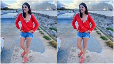 Shehnaaz decked up in a white tank top, teamed with a bright red top and a pair of blue denim shorts.&nbsp; (Instagram/@shehnaazgill)