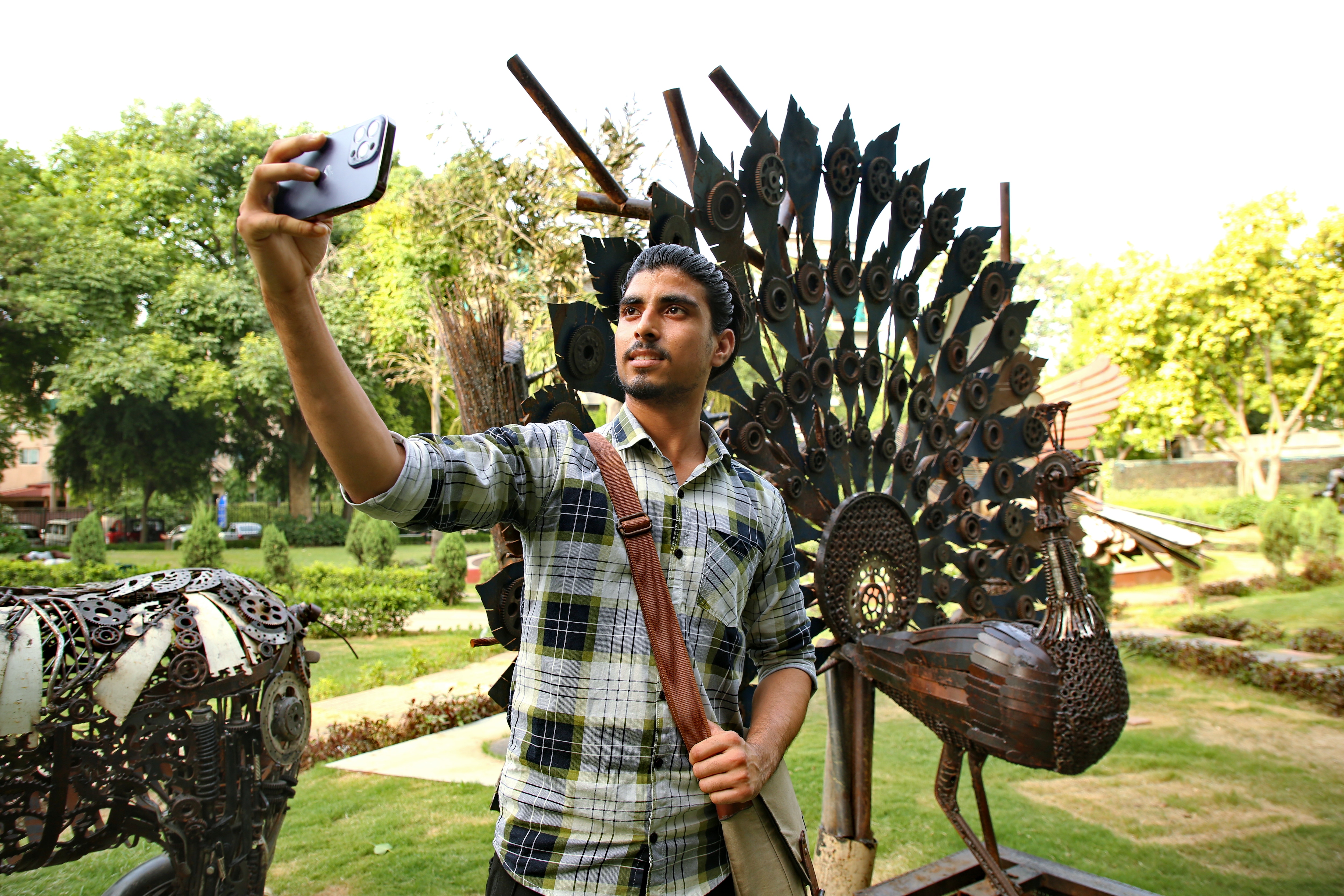 A social media influencer, Jaiveer Singh poses for a selfie in front of a flying peacock made by Delhi-based artist Amit Kumar Sinha. (Photo: Raajessh Kashyap/HT) A social media influencer, Jaiveer Singh poses for a selfie in front of a flying peacock made by Delhi-based artist Amit Kumar Sinha. (Photo: Raajessh Kashyap/HT)