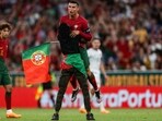 A supporter invades the pitch and grabs Portugal's forward Cristiano Ronaldo during the UEFA Euro 2024 group J qualification football match