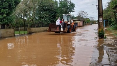 A family crosses a flooded street on a loader in the city of Novo Hamburgo, Rio Grande do Sul State, after an extratropical cyclone hit the southern region of Brazil. (AFP) A family crosses a flooded street on a loader in the city of Novo Hamburgo, Rio Grande do Sul State, after an extratropical cyclone hit the southern region of Brazil. (AFP)