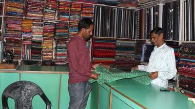 Balle Khan, father of Mohammed Ashraf, at their garment shop in Purola after it was opened on Saturday (HT Photo/Rajeeb Kala)