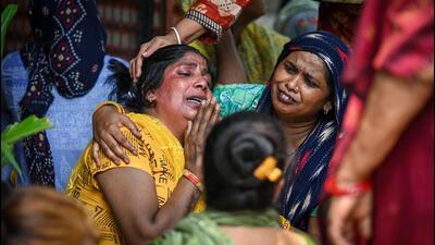 Family members of the deceased at Ambedkar Basti in RK Puram in New Delhi on Sunday. (Sanchit Khanna/HT Photo)