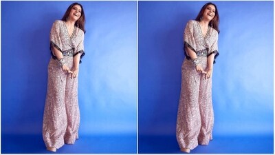 She wears a dusty rose-coloured ensemble that includes a wrap top styled like a kaftan, featuring a V-neckline and flared bottoms with a floral print throughout. The addition of a belt embellished with sequins and mirror work enhances her outfit. (Instagram/@mohitrai) She wears a dusty rose-coloured ensemble that includes a wrap top styled like a kaftan, featuring a V-neckline and flared bottoms with a floral print throughout. The addition of a belt embellished with sequins and mirror work enhances her outfit. (Instagram/@mohitrai)
