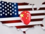 Chinese Spy Balloon: A printed balloon with Chinese flag is placed on a US flag in the shape of US map outline, in this illustration.