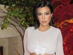 Kourtney Kardashian revealed her pregnancy on Friday, June 16, holding up a handwritten sign during her husband’s Los Angeles concert (kourtneykardash/Instagram)