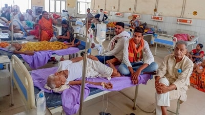 Family members of patients admitted at a hospital due to heatwave conditions, in Ballia. (PTI) Family members of patients admitted at a hospital due to heatwave conditions, in Ballia. (PTI)
