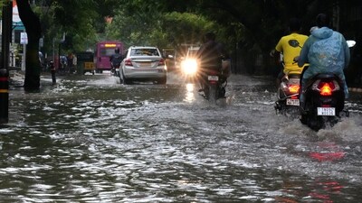 Motorcyclists drive past the waterlogged Rajiv Gandhi IT Expressway after rainfall, in Chennai. (PTI) Motorcyclists drive past the waterlogged Rajiv Gandhi IT Expressway after rainfall, in Chennai. (PTI)