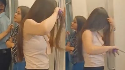 Woman uses hair straightener in Delhi Metro. (Twitter/@HasnaZarooriHai ) Woman uses hair straightener in Delhi Metro. (Twitter/@HasnaZarooriHai )