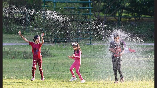 Children frolicking in the sprinklers at Rose Garden in Sector 16, Chandigarh, on a sultry Monday afternoon. (Ravi Kumar/HT)