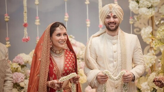 Drisha Acharya was a beautiful bride in a red lehenga and completed her outfit with a mangtika and gold neckpiece. Karan Deol chose an off-white sherwani and a matching turban paired with a stole and pearl necklace.&nbsp;