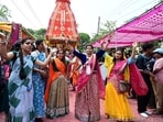 Devotees danced in the annual Jagannath Rath Yatra. As part of elaborate arrangements for the Rath Yatra in Odisha, the government deployed 180 platoons (1 platoon comprises 30 personnel) of security forces in the seaside pilgrim town. A total of 125 special trains will travel to Puri during the festival and a large number of CCTV cameras assisted by drone cameras will function during the ‘Rath Yatra’.(HT Photo/Keshav Singh)
