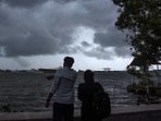 People enjoy weather as dark clouds cover the city skyline during the onset of monsoon over Kerala a week later than usual, in Kochi (PTI) People enjoy weather as dark clouds cover the city skyline during the onset of monsoon over Kerala a week later than usual, in Kochi (PTI)