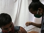 A Covid jab is administered to a person by a health official.