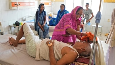 A woman wipes the head of her ailing brother to keep him cool from the heat wave by using a wet cloth at the district hospital in Ballia. While northern regions of India are known for sweltering heat during the summer months, temperatures have been consistently above normal, according to the Indian Meteorological Department. Adding to the heat stress are consistent power outages across the region, leaving people with no running water, fans, or air conditioners, said AP. (Rajesh Kumar Singh / AP) A woman wipes the head of her ailing brother to keep him cool from the heat wave by using a wet cloth at the district hospital in Ballia. While northern regions of India are known for sweltering heat during the summer months, temperatures have been consistently above normal, according to the Indian Meteorological Department. Adding to the heat stress are consistent power outages across the region, leaving people with no running water, fans, or air conditioners, said AP. (Rajesh Kumar Singh / AP)