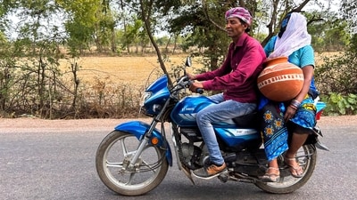 A woman carries an earthen pot used to store water, as she takes a ride on a motorcycle on a hot summer afternoon, in Lalitpur district, UP. (Rajesh Kumar Singh / AP) A woman carries an earthen pot used to store water, as she takes a ride on a motorcycle on a hot summer afternoon, in Lalitpur district, UP. (Rajesh Kumar Singh / AP)