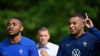 France's forward Kylian Mbappe (R) speaks with France's forward Christopher Nkunku before a training session (AFP) France's forward Kylian Mbappe (R) speaks with France's forward Christopher Nkunku before a training session (AFP)