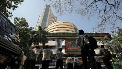 People look at a screen displaying the Sensex results on the facade of the Bombay Stock Exchange (BSE) building in Mumbai. (REUTERS)