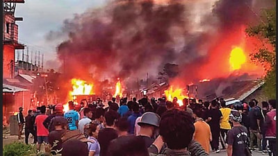 People at the site of fire in Manipur. (PTI) People at the site of fire in Manipur. (PTI)