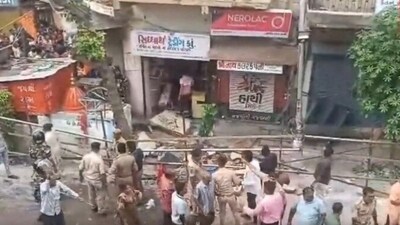 Police personnel standing at the spot where the balcony collapsed in Ahmedabad's Dariapur area. (Twitter/PTI) Police personnel standing at the spot where the balcony collapsed in Ahmedabad's Dariapur area. (Twitter/PTI)