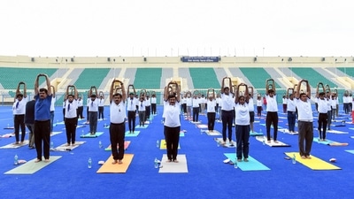 Participants perform yoga on the eve of 'Yoga Mahotsav 2023', at Major Dhyan Chand National Stadium in New Delhi on Tuesday. (ANI)