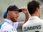 England's Ben Stokes with Australia's Pat Cummins after Australia win the first Test