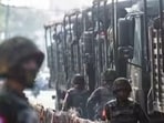 Myanmar: A soldier stand next to military vehicles as people gather to protest against a military coup in Yangon, Myanmar.
